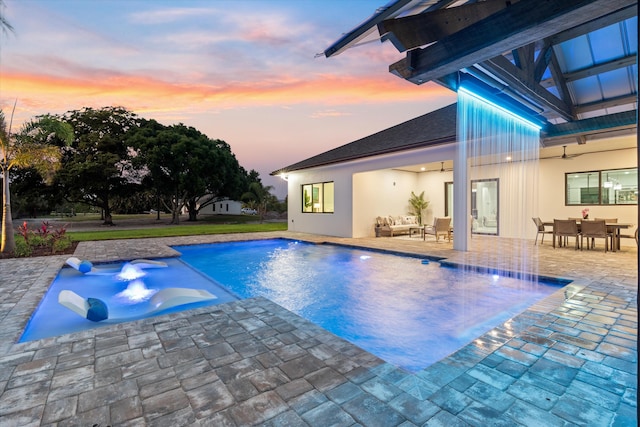 16149 73rd Ter N, West Palm Beach, FL 33418 - pool at dusk with an outdoor pool, a patio, and outdoor dining space