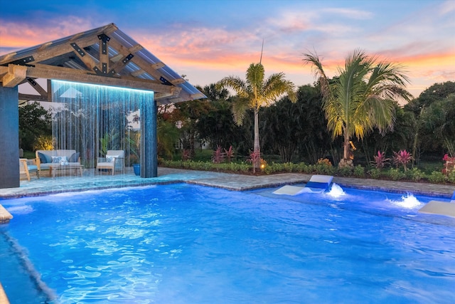 16149 73rd Ter N, West Palm Beach, FL 33418 - pool at dusk featuring an outdoor pool and a patio area