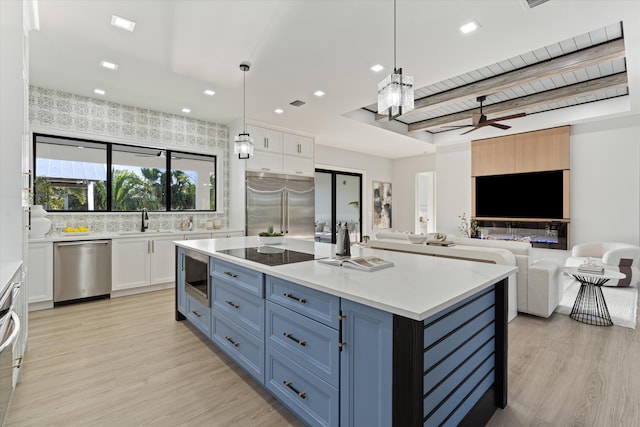 16149 73rd Ter N, West Palm Beach, FL 33418 - kitchen with built in appliances, a sink, white cabinetry, blue cabinetry, and recessed lighting