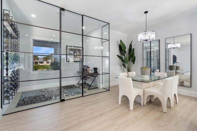16149 73rd Ter N, West Palm Beach, FL 33418 - dining area with a chandelier, wood finished floors, and baseboards