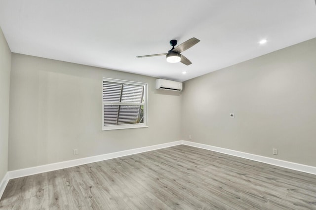 825 Northern Dr, Lake Park, FL 33403 - unfurnished room with an AC wall unit, wood finished floors, a ceiling fan, baseboards, and recessed lighting