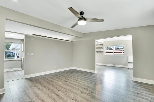825 Northern Dr, Lake Park, FL 33403 - unfurnished room with wood finished floors, a ceiling fan, baseboards, and beamed ceiling