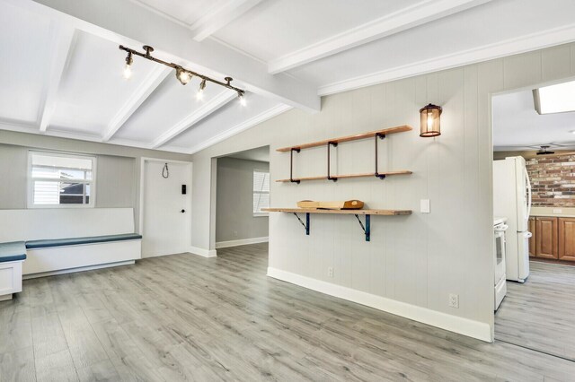 825 Northern Dr, Lake Park, FL 33403 - unfurnished living room featuring light wood-type flooring, baseboards, and rail lighting