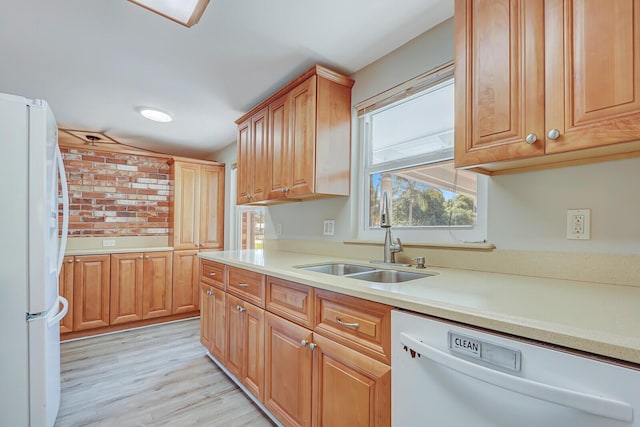 825 Northern Dr, Lake Park, FL 33403 - kitchen featuring white appliances, a sink, light countertops, and light wood-type flooring