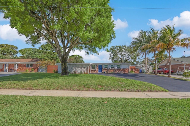 825 Northern Dr, Lake Park, FL 33403 - view of front of home featuring a front lawn and brick siding