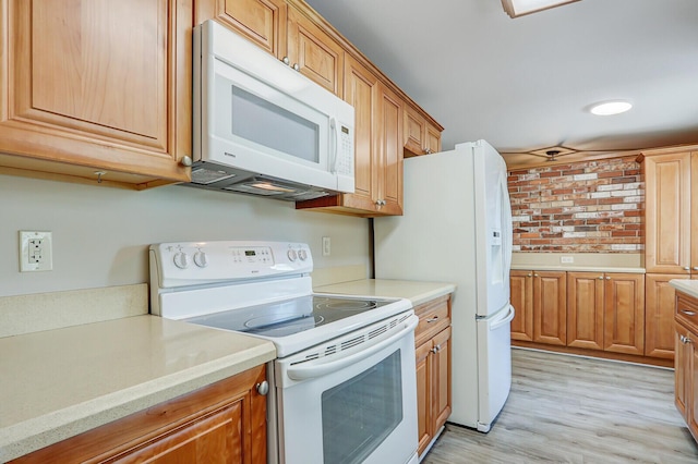 825 Northern Dr, Lake Park, FL 33403 - kitchen featuring white appliances, light wood-type flooring, and brown cabinetry