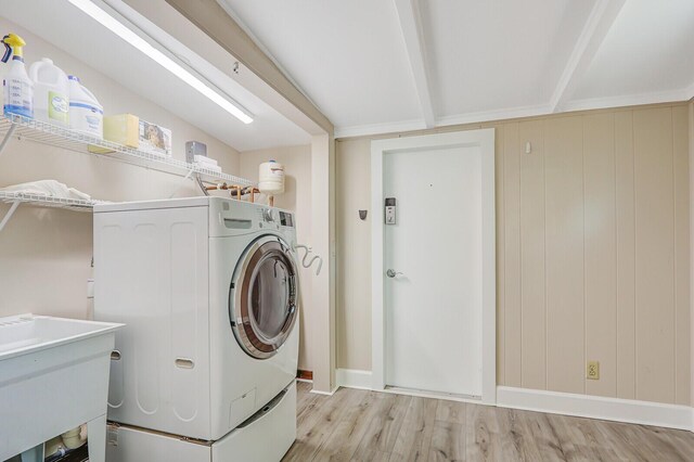 825 Northern Dr, Lake Park, FL 33403 - laundry room with light wood-type flooring, washer and clothes dryer, and baseboards