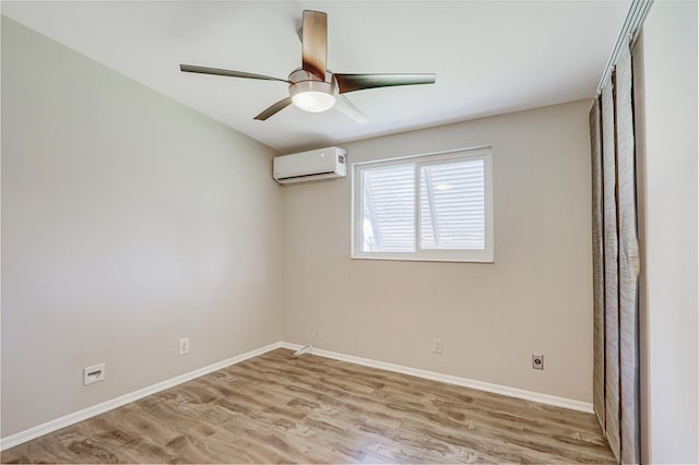 825 Northern Dr, Lake Park, FL 33403 - empty room with a wall mounted AC, wood finished floors, baseboards, and ceiling fan