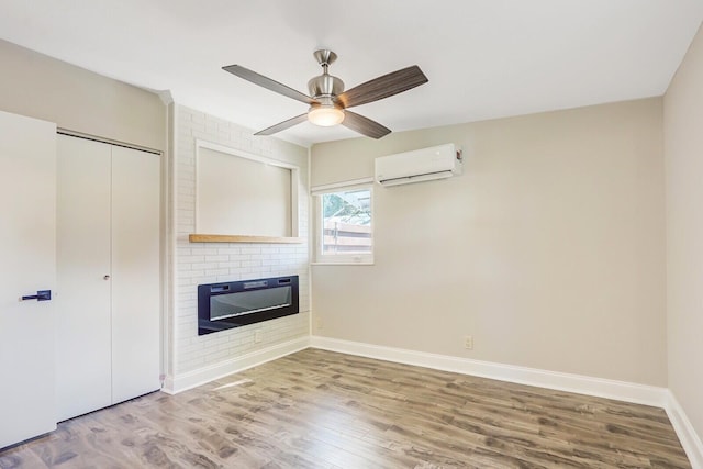 825 Northern Dr, Lake Park, FL 33403 - unfurnished living room featuring a wall unit AC, a brick fireplace, baseboards, wood finished floors, and ceiling fan
