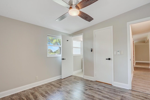 825 Northern Dr, Lake Park, FL 33403 - unfurnished bedroom featuring wood finished floors, baseboards, lofted ceiling, and a ceiling fan
