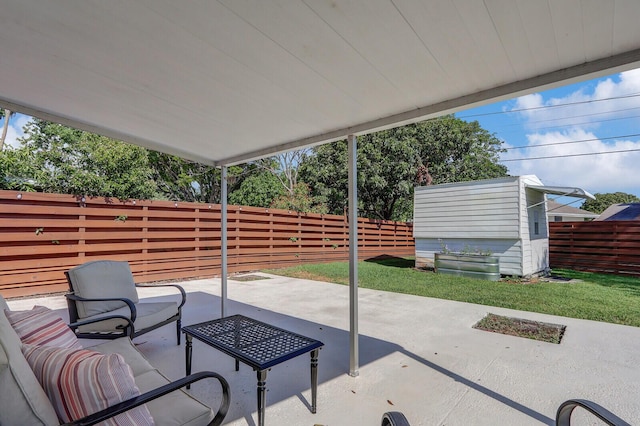825 Northern Dr, Lake Park, FL 33403 - view of patio / terrace with a fenced backyard, a storage shed, and an outbuilding