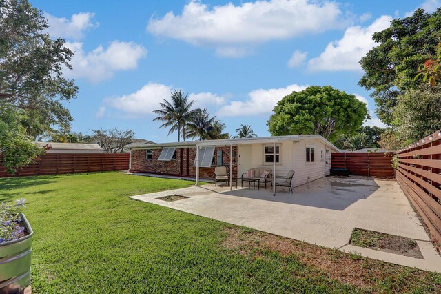 825 Northern Dr, Lake Park, FL 33403 - rear view of house with a patio area