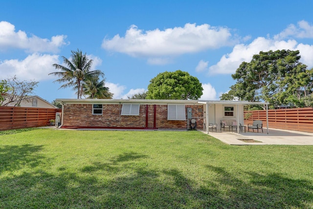 825 Northern Dr, Lake Park, FL 33403 - back of house featuring a patio area and brick siding