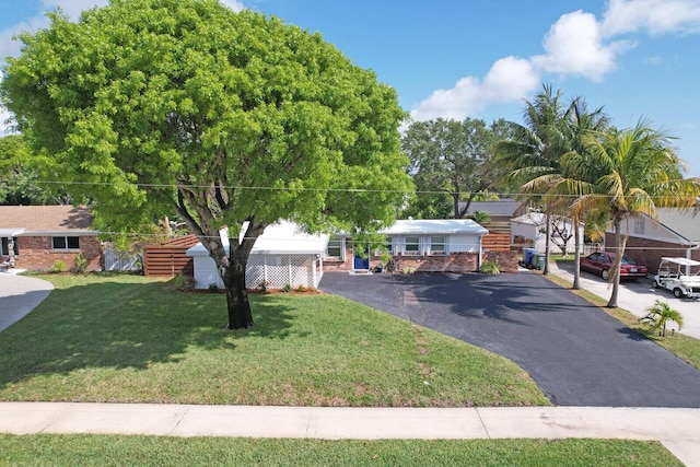 825 Northern Dr, Lake Park, FL 33403 - view of front of property with a front lawn and asphalt driveway