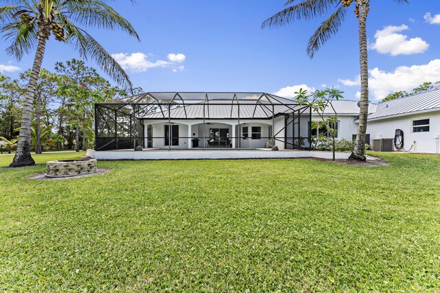 14819 Broken Arrow Pl, Palm Beach Gardens, FL 33418 - back of property featuring a yard, an outdoor fire pit, a patio area, and a lanai