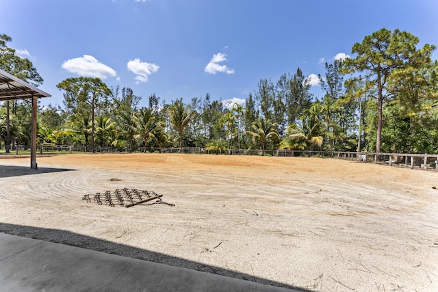 14819 Broken Arrow Pl, Palm Beach Gardens, FL 33418 - view of yard featuring an enclosed riding area and view of wooded area