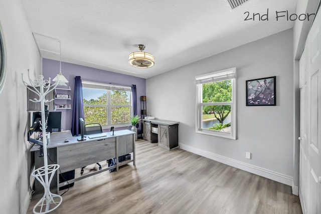 office area with light wood-type flooring and baseboards