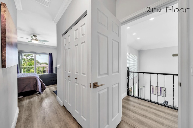 hallway featuring wood finished floors, crown molding, recessed lighting, and baseboards