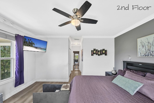bedroom featuring wood finished floors, crown molding, baseboards, and ceiling fan