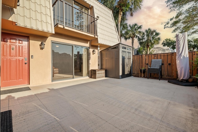 6824 68th Way, West Palm Beach, FL 33409 - back of house with mansard roof, stucco siding, a patio area, and a balcony