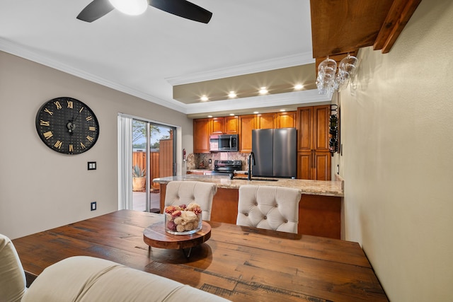 6824 68th Way, West Palm Beach, FL 33409 - dining room with ornamental molding, ceiling fan, and a tray ceiling