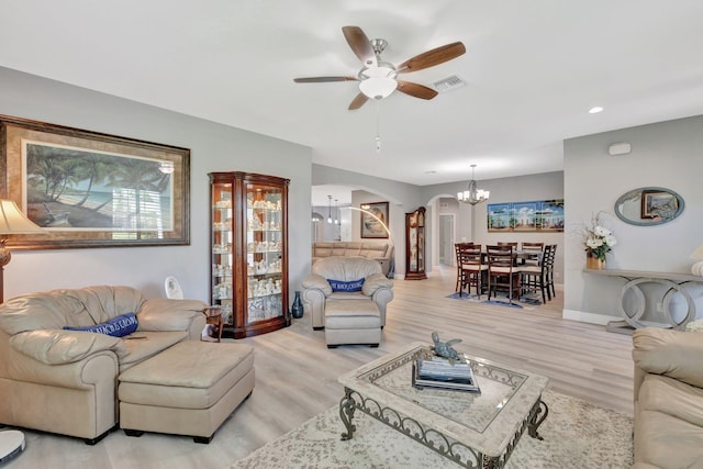1236 SE Conference Cir, Stuart, FL 34997 - living room with arched walkways, a chandelier, ceiling fan, light wood-type flooring, and recessed lighting
