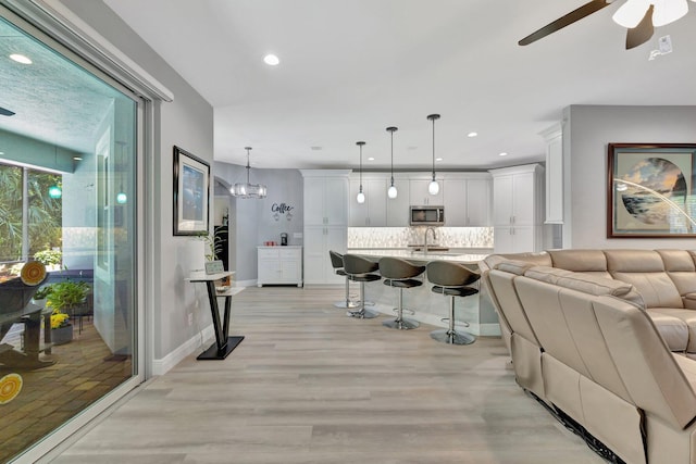 1236 SE Conference Cir, Stuart, FL 34997 - living area featuring light wood-style flooring, a ceiling fan, and recessed lighting