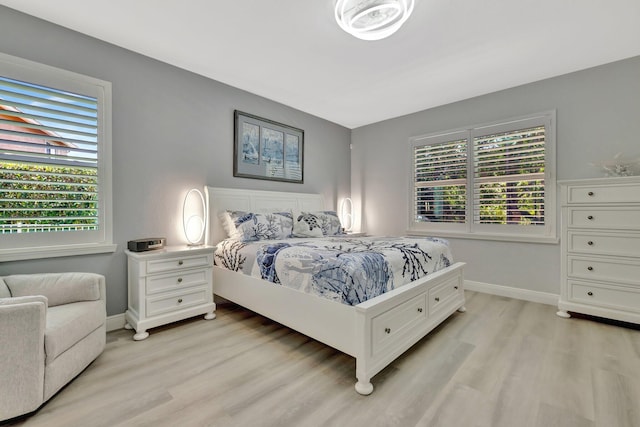 1236 SE Conference Cir, Stuart, FL 34997 - bedroom with light wood-type flooring and baseboards