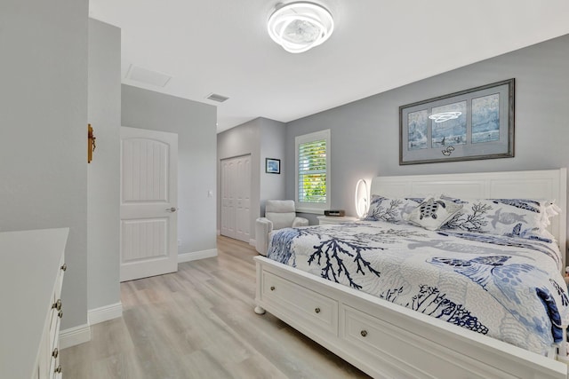 1236 SE Conference Cir, Stuart, FL 34997 - bedroom with light wood-style flooring and a closet
