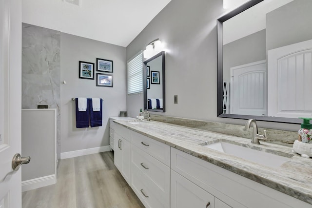 1236 SE Conference Cir, Stuart, FL 34997 - bathroom featuring double vanity and wood finished floors