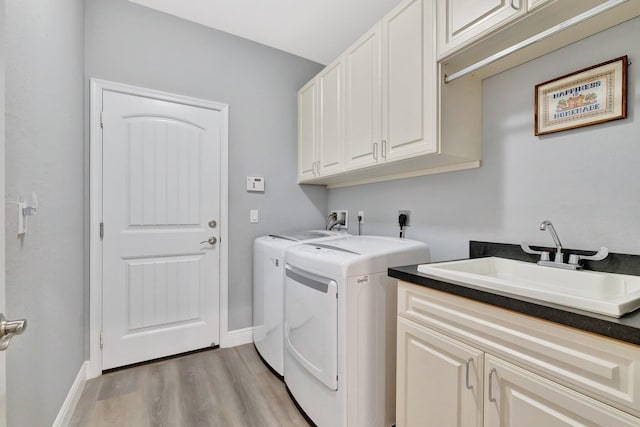 1236 SE Conference Cir, Stuart, FL 34997 - laundry room with cabinet space, washing machine and clothes dryer, and light wood finished floors