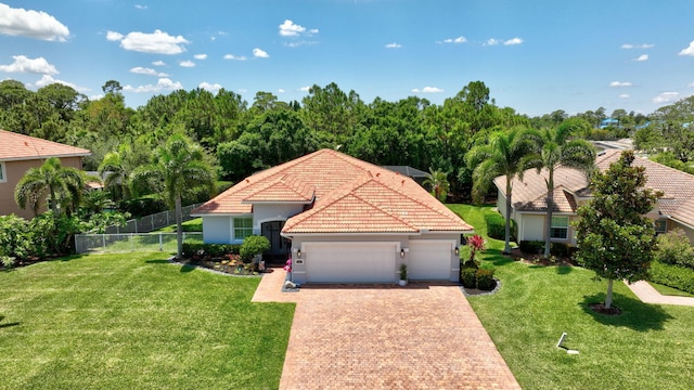 1236 SE Conference Cir, Stuart, FL 34997 - mediterranean / spanish-style home featuring an attached garage, decorative driveway, a tile roof, and stucco siding