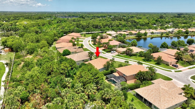 1236 SE Conference Cir, Stuart, FL 34997 - aerial perspective of suburban area with a heavily wooded area and a large body of water