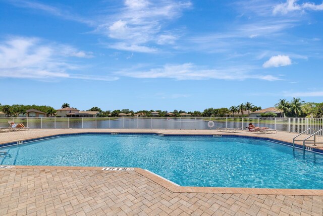 1236 SE Conference Cir, Stuart, FL 34997 - community pool featuring a patio and a water view