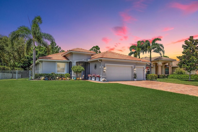 1236 SE Conference Cir, Stuart, FL 34997 - mediterranean / spanish-style house featuring a tiled roof, driveway, an attached garage, and stucco siding