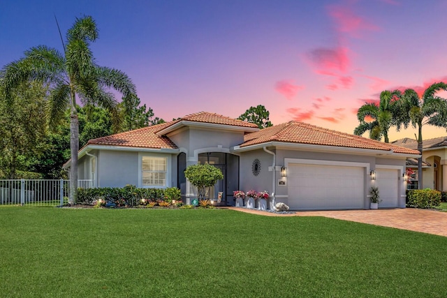 1236 SE Conference Cir, Stuart, FL 34997 - mediterranean / spanish-style home featuring an attached garage, driveway, a tiled roof, and stucco siding