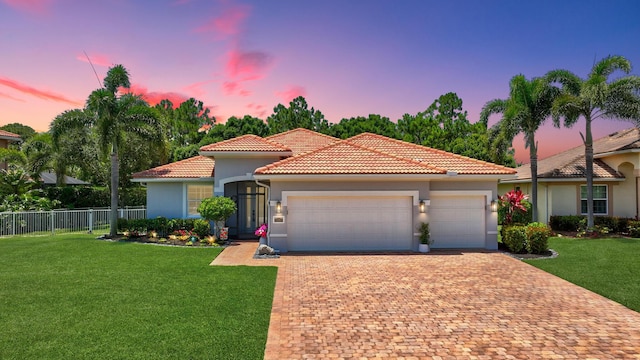1236 SE Conference Cir, Stuart, FL 34997 - mediterranean / spanish home with a garage, decorative driveway, stucco siding, and a tile roof