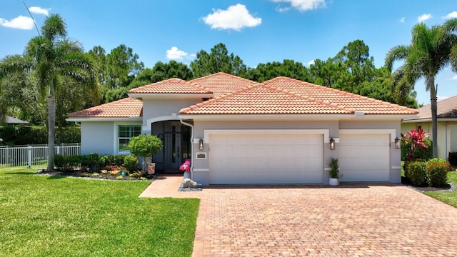 1236 SE Conference Cir, Stuart, FL 34997 - mediterranean / spanish house with decorative driveway, a garage, stucco siding, and a tile roof