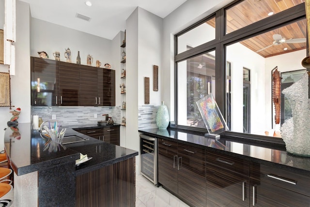 2783 Rhone Dr, Palm Beach Gardens, FL 33410 - bar with beverage cooler, backsplash, light marble finish floors, and a sink