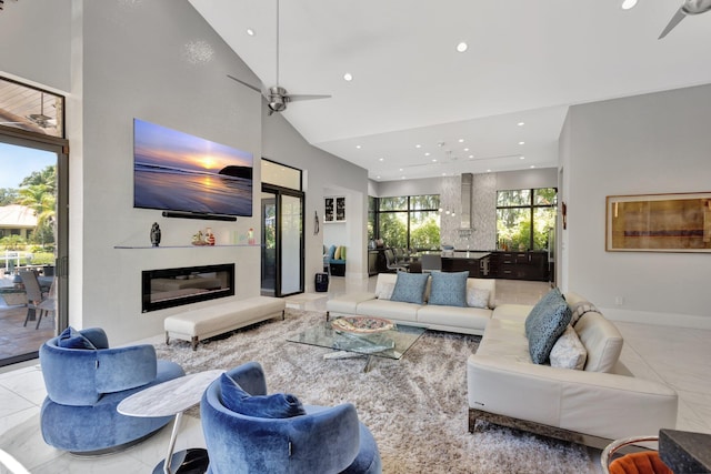 2783 Rhone Dr, Palm Beach Gardens, FL 33410 - living area with ceiling fan, recessed lighting, a glass covered fireplace, baseboards, and high vaulted ceiling