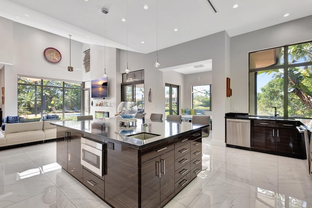 2783 Rhone Dr, Palm Beach Gardens, FL 33410 - kitchen with open floor plan, stainless steel appliances, a sink, dark countertops, and recessed lighting
