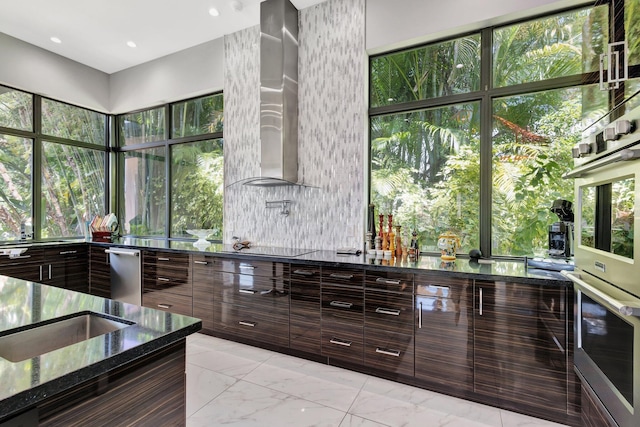 2783 Rhone Dr, Palm Beach Gardens, FL 33410 - kitchen featuring modern cabinets, dark stone counters, a sink, appliances with stainless steel finishes, and light marble finish flooring