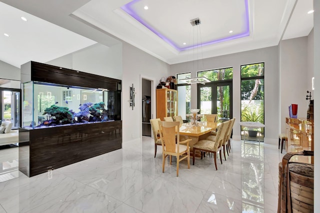 2783 Rhone Dr, Palm Beach Gardens, FL 33410 - dining room featuring a raised ceiling, recessed lighting, a high ceiling, french doors, and light marble finish flooring