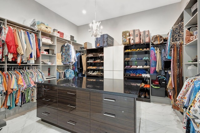 2783 Rhone Dr, Palm Beach Gardens, FL 33410 - walk in closet featuring light marble finish flooring and a chandelier