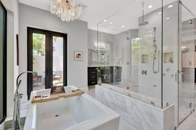 2783 Rhone Dr, Palm Beach Gardens, FL 33410 - bathroom featuring french doors, a freestanding bath, a shower stall, a chandelier, and recessed lighting