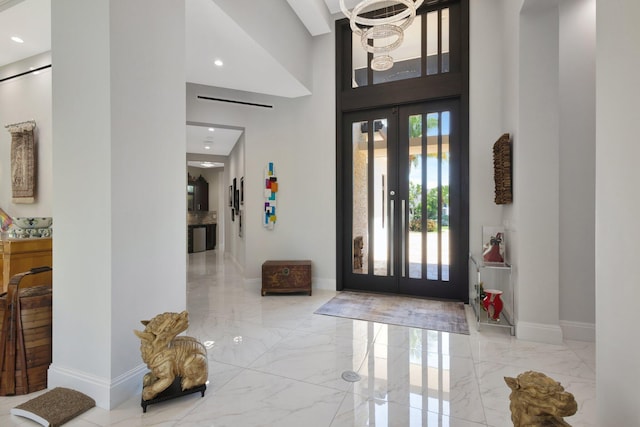 2783 Rhone Dr, Palm Beach Gardens, FL 33410 - entrance foyer with marble tiled floors, a towering ceiling, baseboards, recessed lighting, and french doors