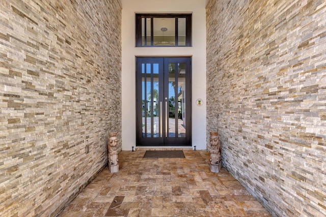 2783 Rhone Dr, Palm Beach Gardens, FL 33410 - view of exterior entry with french doors and stucco siding
