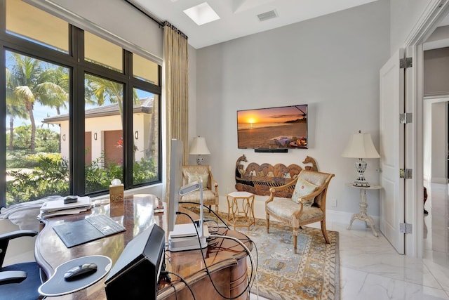 2783 Rhone Dr, Palm Beach Gardens, FL 33410 - living area featuring plenty of natural light, marble look tile flooring, and a skylight