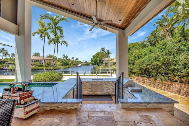 2783 Rhone Dr, Palm Beach Gardens, FL 33410 - view of patio / terrace featuring an outdoor kitchen, a water view, ceiling fan, and an outdoor pool