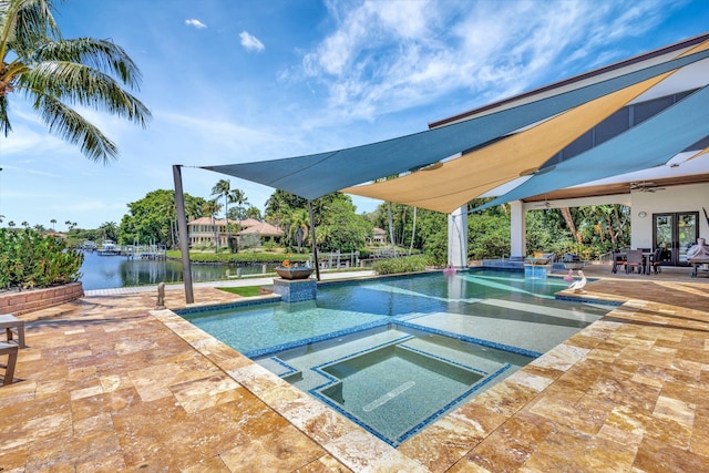 2783 Rhone Dr, Palm Beach Gardens, FL 33410 - view of pool featuring a patio, a ceiling fan, a water view, french doors, and a pool with connected hot tub